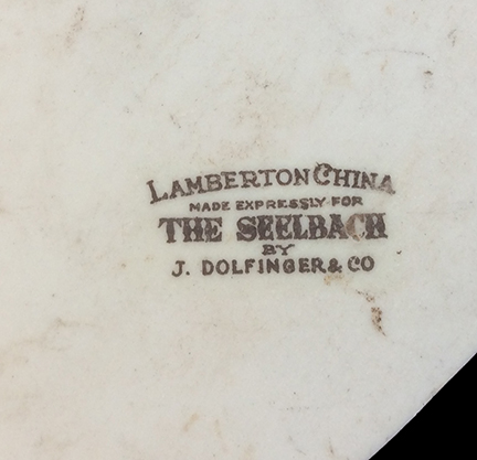 Platter or similar large flat vessel. Unglazed bisque waster. Decal coat of arms, 10.0 mm thick. Decal manufacturer’s mark “Lamberton China Made Expressly for the Seelbach by J. Dolfinger & Co.”